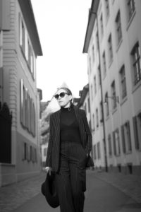 Woman in black on street in historic part of Basel